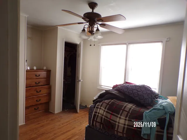 a bedroom with a bed and a chandelier