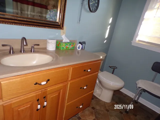 a bathroom with a toilet sink and mirror