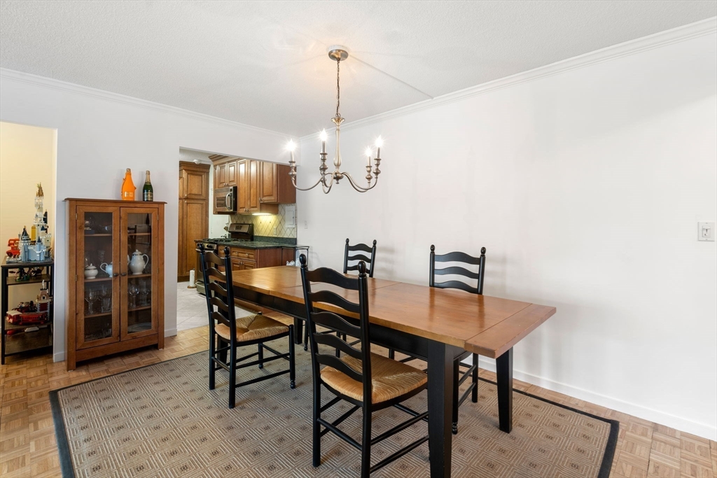33 Pond Avenue, Unit 405 Brookline, MA 02445 - Photo 4 of 17 a dining room with furniture and window