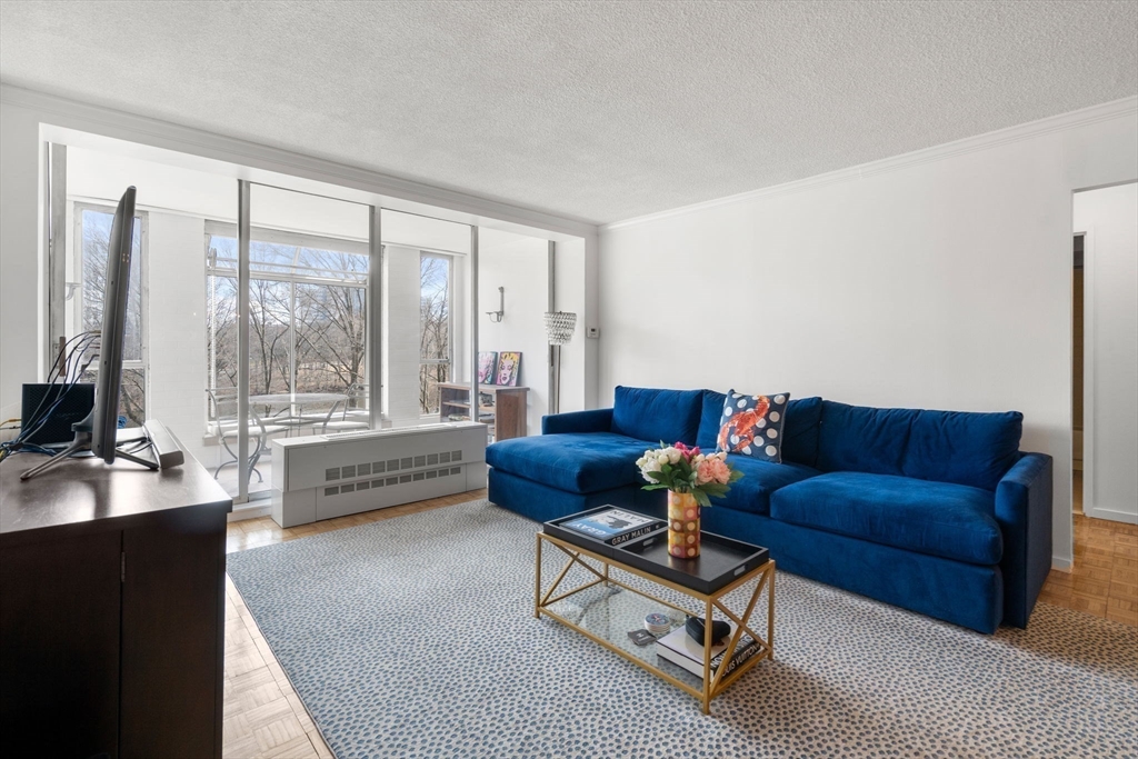 33 Pond Avenue, Unit 405 Brookline, MA 02445 - Photo 5 of 17 a living room with furniture and a large window