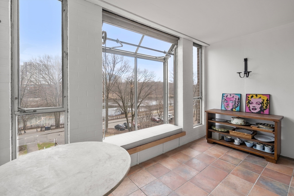 33 Pond Avenue, Unit 405 Brookline, MA 02445 - Photo 6 of 17 a bedroom with furniture and a large window