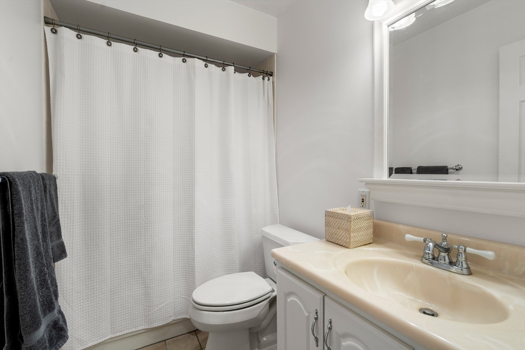 33 Pond Avenue, Unit 405 Brookline, MA 02445 - Photo 9 of 17 a bathroom with a sink toilet and shower