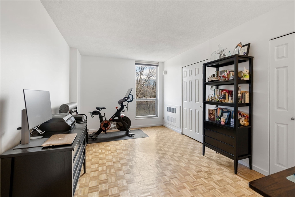 33 Pond Avenue, Unit 405 Brookline, MA 02445 - Photo 10 of 17 a view of a livingroom with workspace and a couch