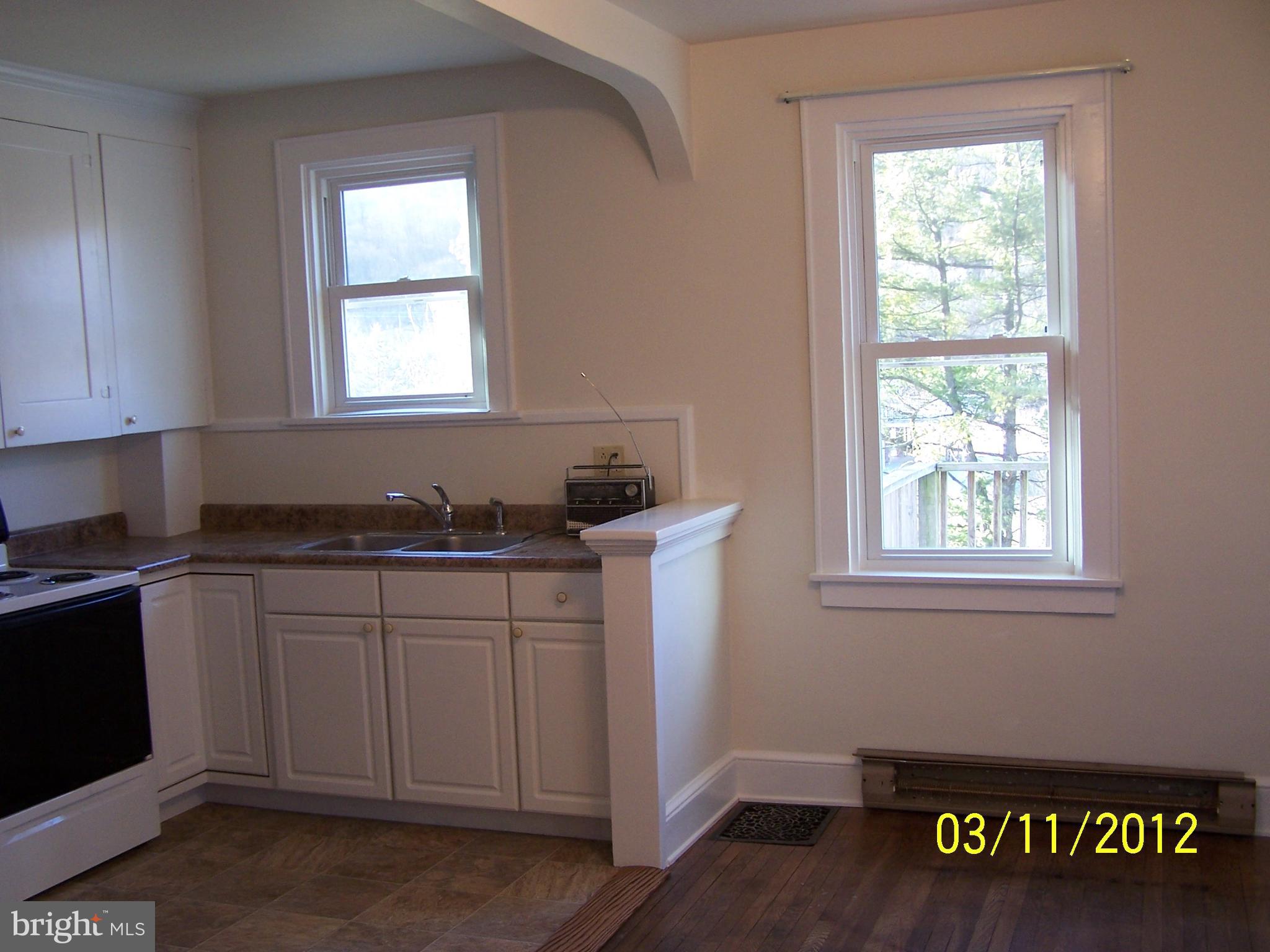 925 West Water Street Bellefonte, PA 16823 - Photo 14 of 23 a kitchen with granite countertop a sink window and cabinets