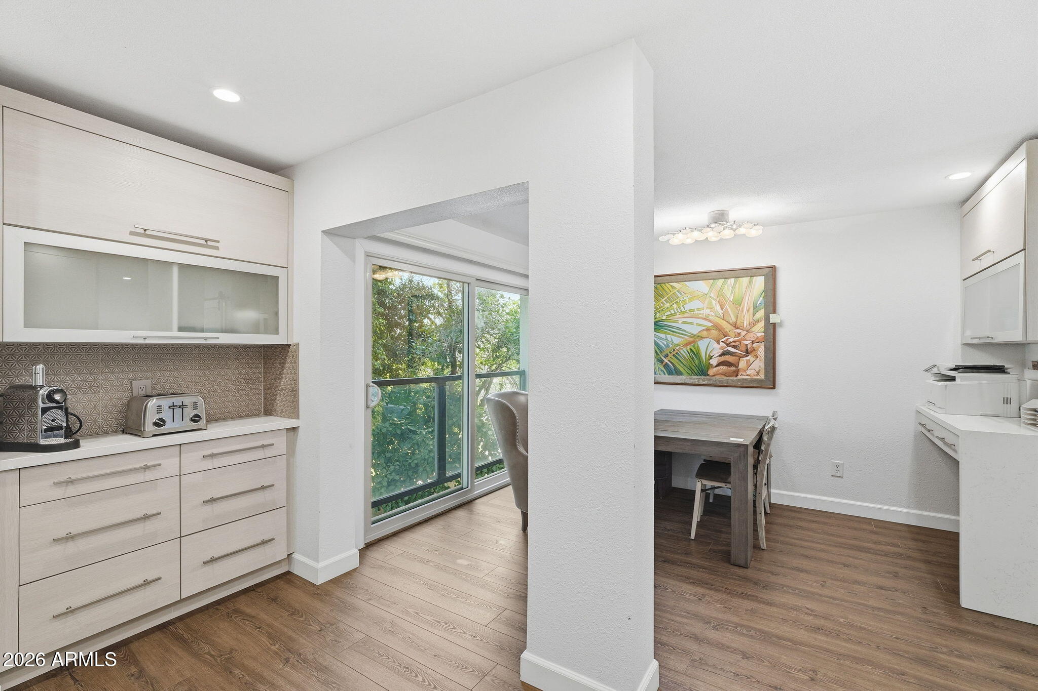 4201 East Camelback Road, Unit 34 Phoenix, AZ 85018 - Photo 5 of 19 a workspace with wooden floor and white walls