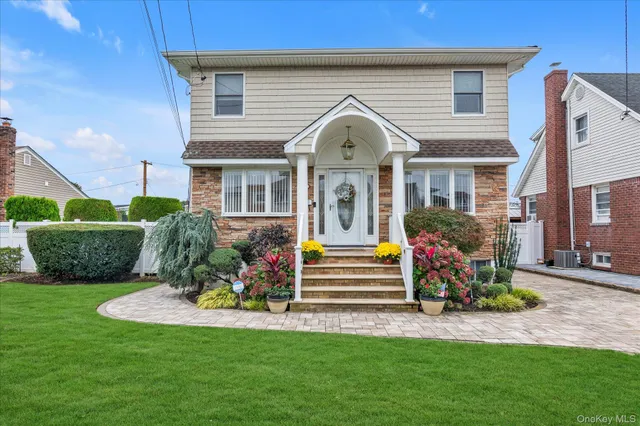 a front view of a house with a garden and plants