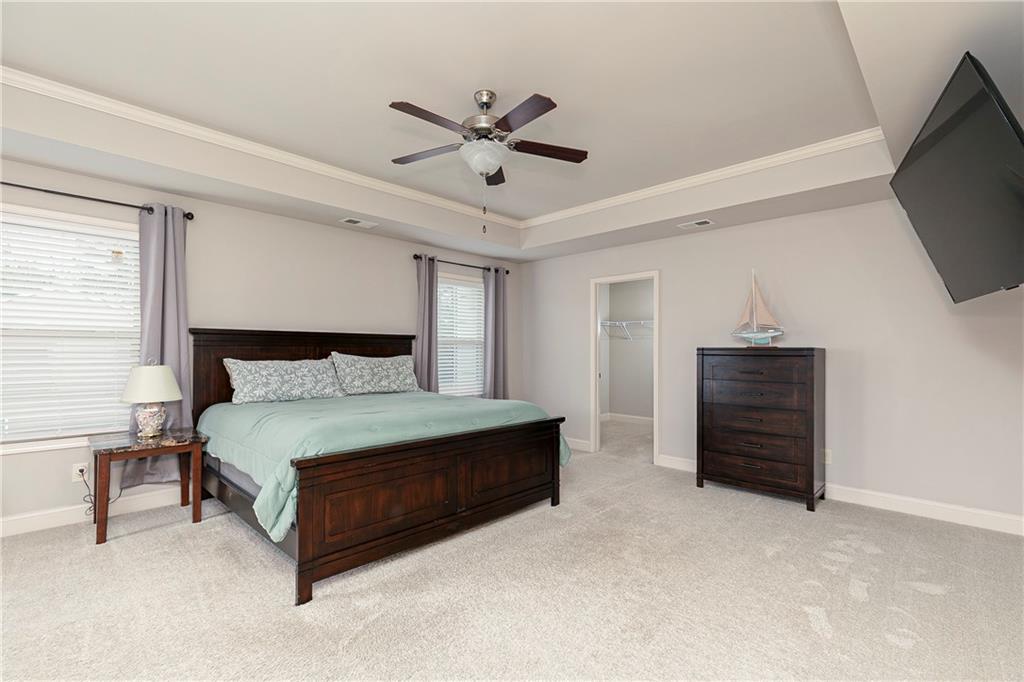 152 Greatwood Lane Villa Rica, GA 30180 - Photo 23 of 48 a bedroom with a bed and a ceiling fan