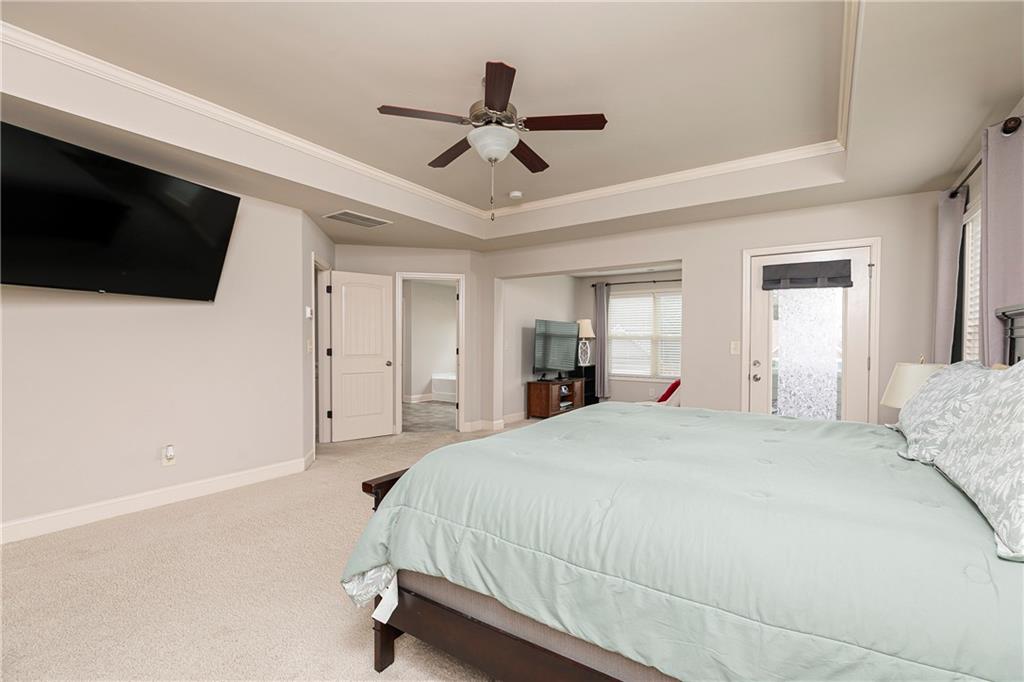 152 Greatwood Lane Villa Rica, GA 30180 - Photo 24 of 48 a spacious bedroom with a bed and a flat screen tv