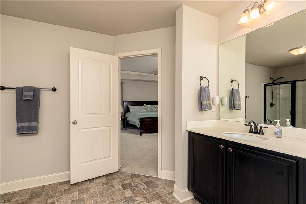 152 Greatwood Lane Villa Rica, GA 30180 - Photo 30 of 48 a en suite bathroom with a sink and a mirror