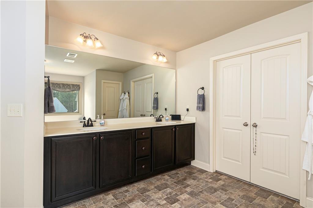 152 Greatwood Lane Villa Rica, GA 30180 - Photo 31 of 48 a spacious bathroom with a double vanity sink and a mirror