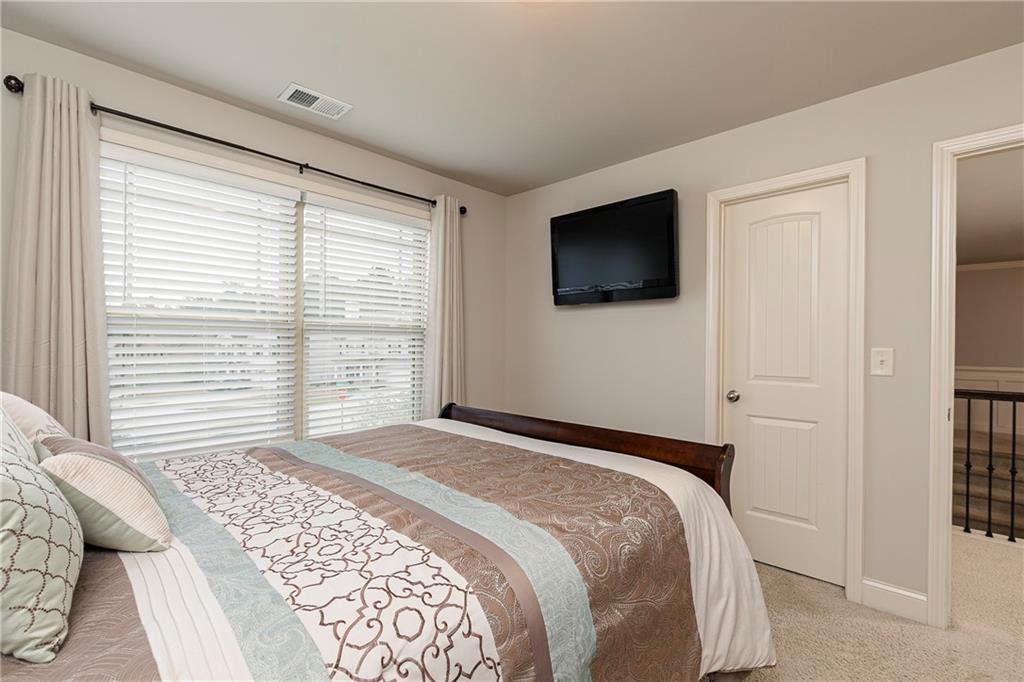 152 Greatwood Lane Villa Rica, GA 30180 - Photo 34 of 48 a bedroom with a bed and a flat screen tv