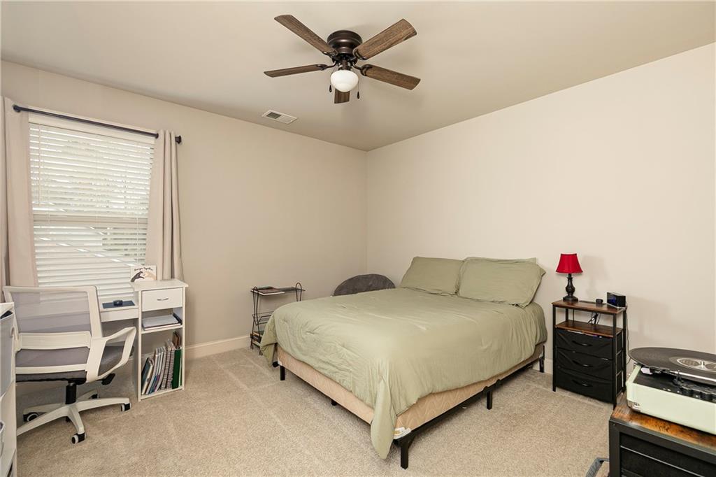 152 Greatwood Lane Villa Rica, GA 30180 - Photo 35 of 48 a bedroom with a bed and a chandelier