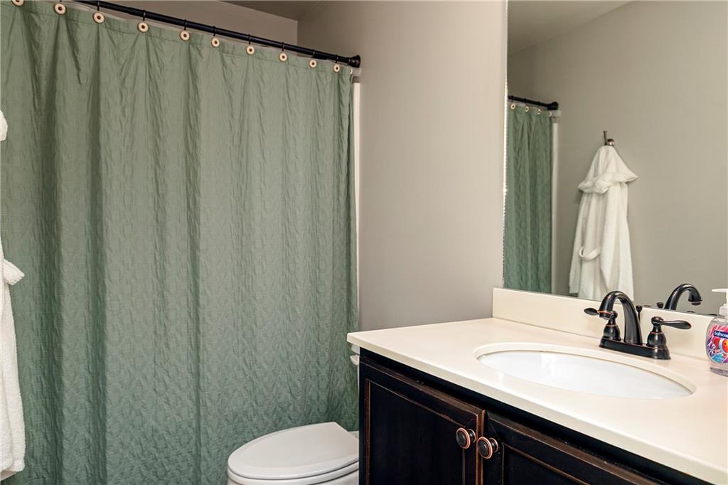 152 Greatwood Lane Villa Rica, GA 30180 - Photo 36 of 48 a bathroom with a sink a toilet a mirror and vanity