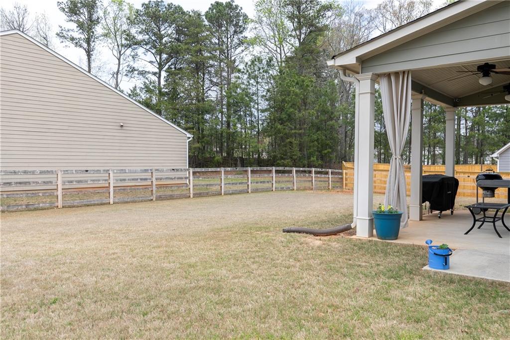 152 Greatwood Lane Villa Rica, GA 30180 - Photo 39 of 48 a view of a backyard with wooden floor and iron fence