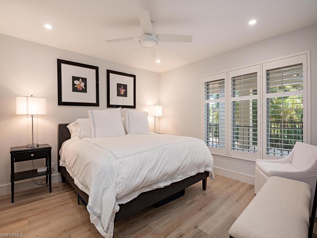 100 Wilderness Way, Unit B348 Naples, FL 34105 - Photo 11 of 15 Bedroom with light hardwood / wood-style floors and ceiling fan