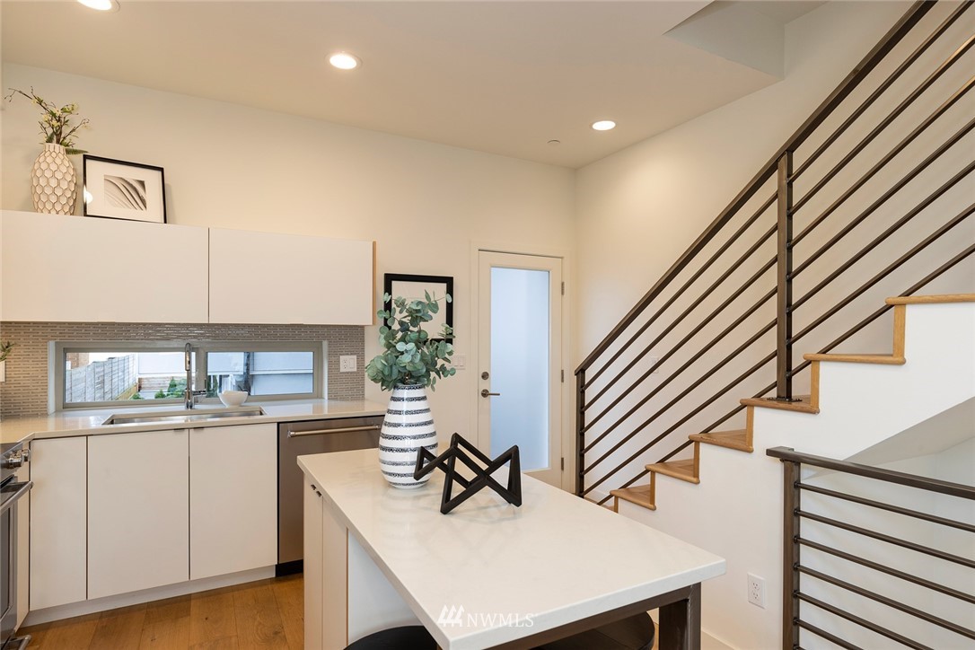 6012 A California Avenue Southwest Seattle, WA 98136 - Photo 12 of 30 a kitchen with a sink a stove and cabinets