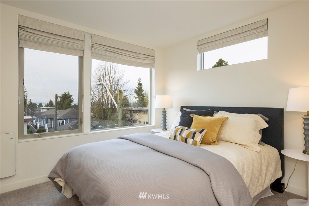 6012 A California Avenue Southwest Seattle, WA 98136 - Photo 15 of 30 a bedroom with a large bed and a large window