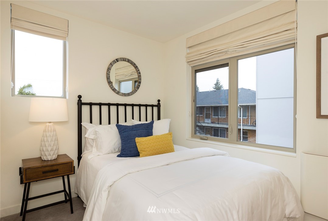 6012 A California Avenue Southwest Seattle, WA 98136 - Photo 19 of 30 a bedroom with a bed and a window in it