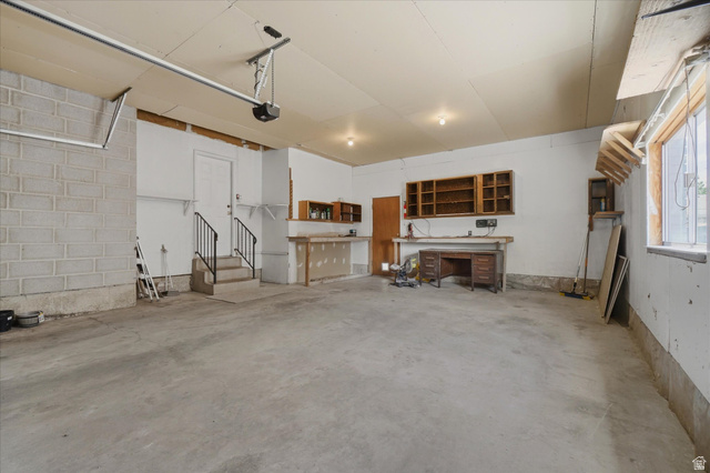 392 Perrine Drive Midvale, UT 84047 - Photo 32 of 37 Spacious garage wit, built-in shelving, and a workshop area