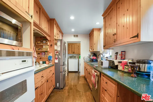 a kitchen with stainless steel appliances granite countertop a sink and cabinets