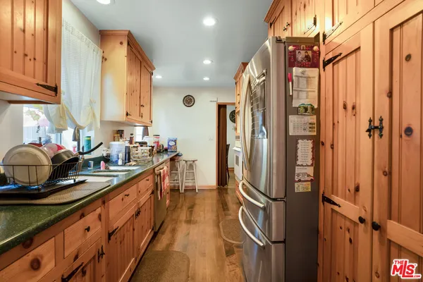 a kitchen with stainless steel appliances a refrigerator sink and cabinets