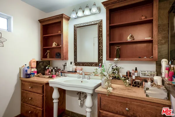 a bathroom with a sink vanity and a mirror
