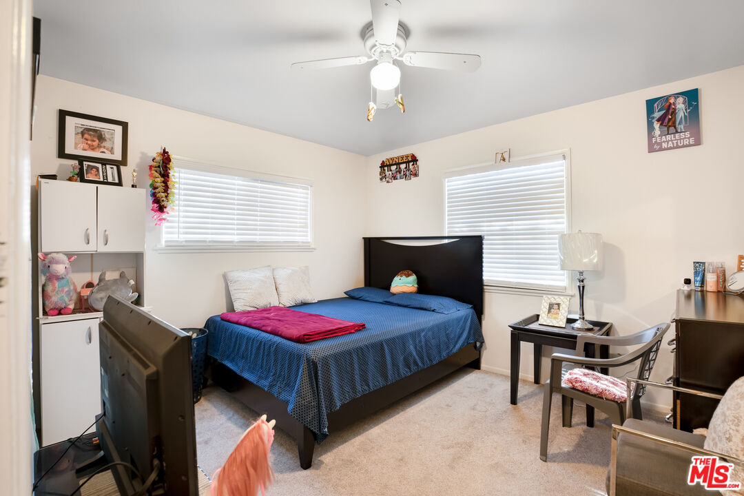 4141 Eileen Street Simi Valley, CA 93063 - Photo 21 of 31 a bedroom with a bed wooden floor and a window