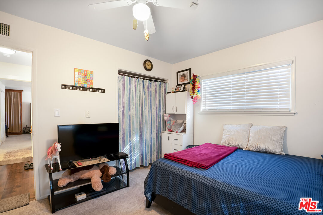 4141 Eileen Street Simi Valley, CA 93063 - Photo 22 of 31 a living room with furniture and a flat screen tv