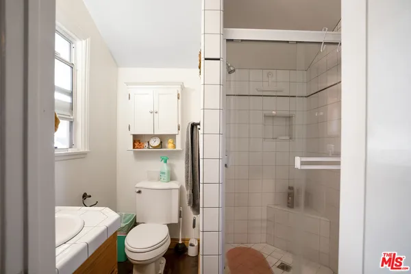 a bathroom with a toilet and shower