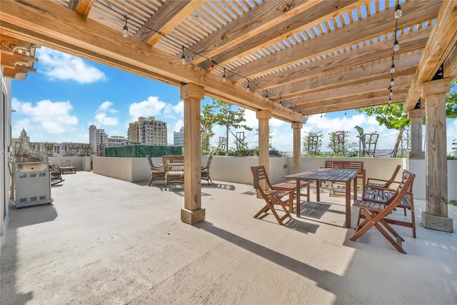 a view of a patio with a table chairs and a backyard
