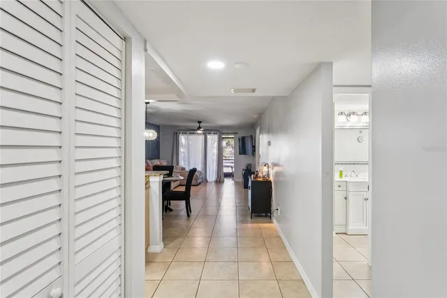 a hallway with a dining table and chairs