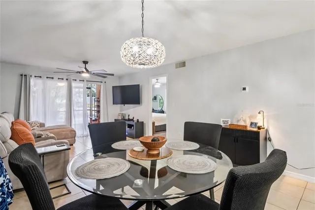 a view of a dining room with furniture a chandelier and window