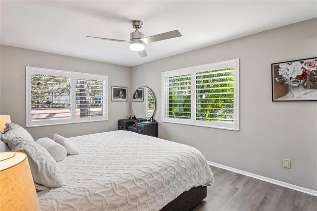 a bedroom with a large bed and a window