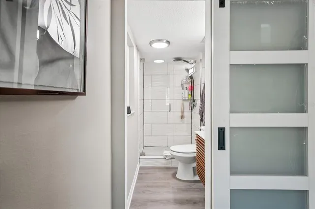 a bathroom with a toilet and a shower