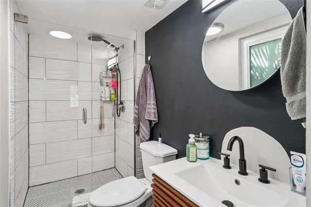 a bathroom with a sink toilet and shower