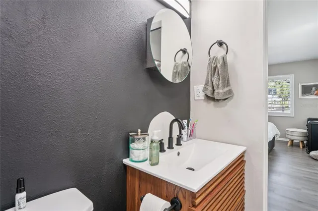 a bathroom with a toilet sink and mirror