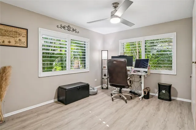 a view of a workspace with furniture and a window