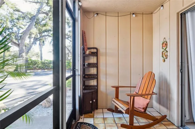 a view of a balcony with chairs and table in the balcony