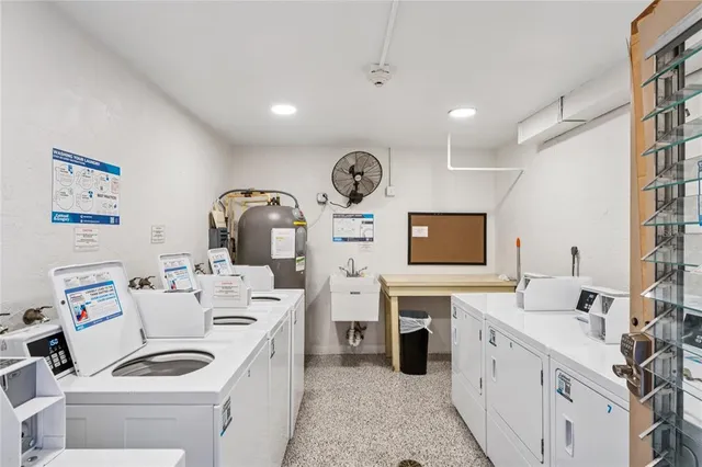 a very nice looking room with a large window and dresser