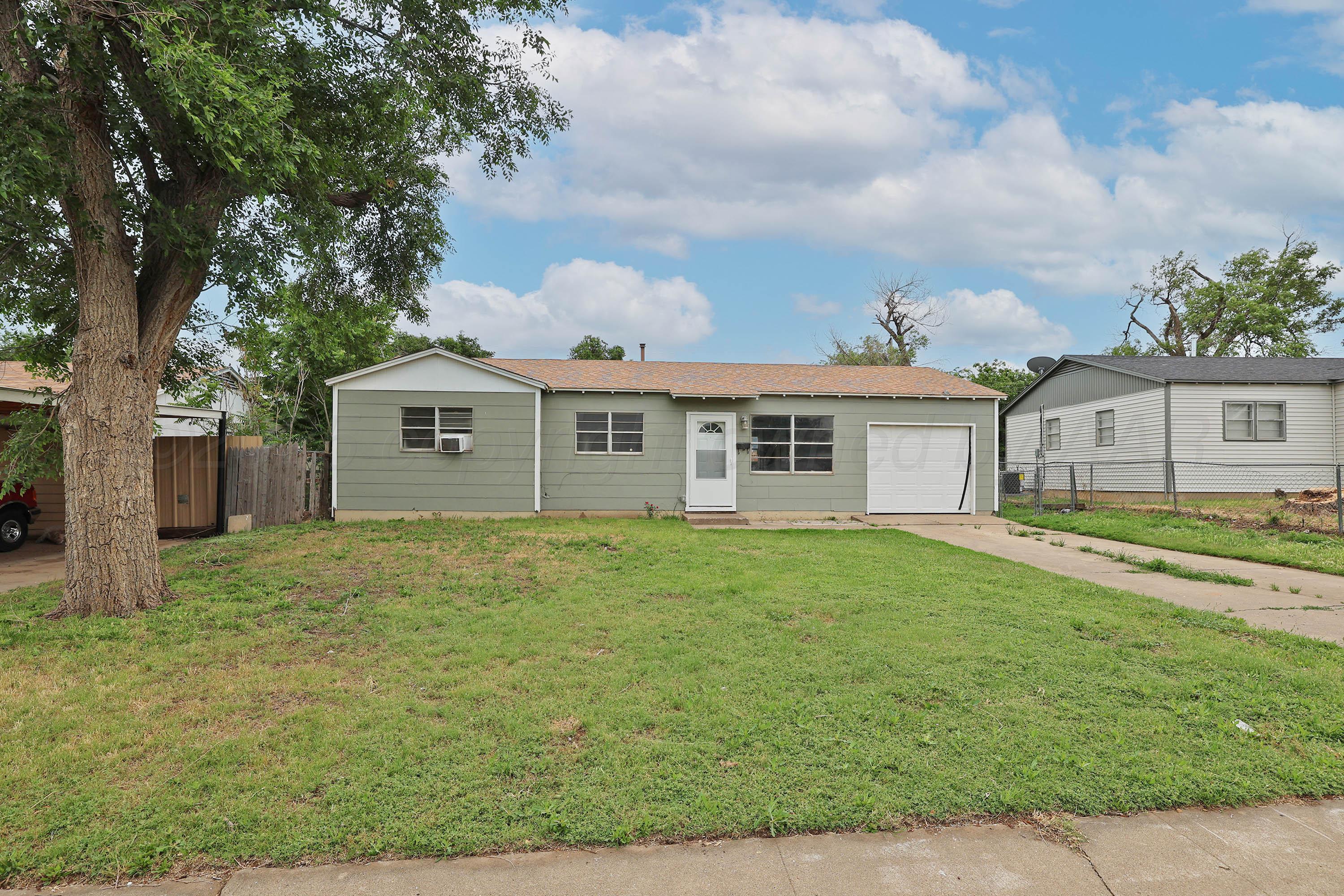 3810 Mesa Verde Drive Amarillo, TX 79107 - Photo 1 of 21 a front view of a house with a garden