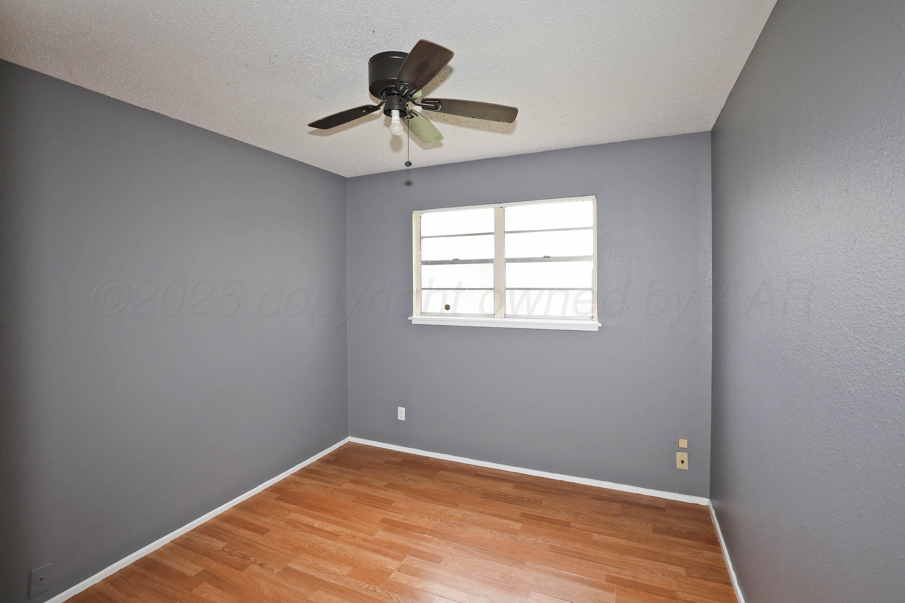 3810 Mesa Verde Drive Amarillo, TX 79107 - Photo 12 of 21 a view of empty room with wooden floor and fan