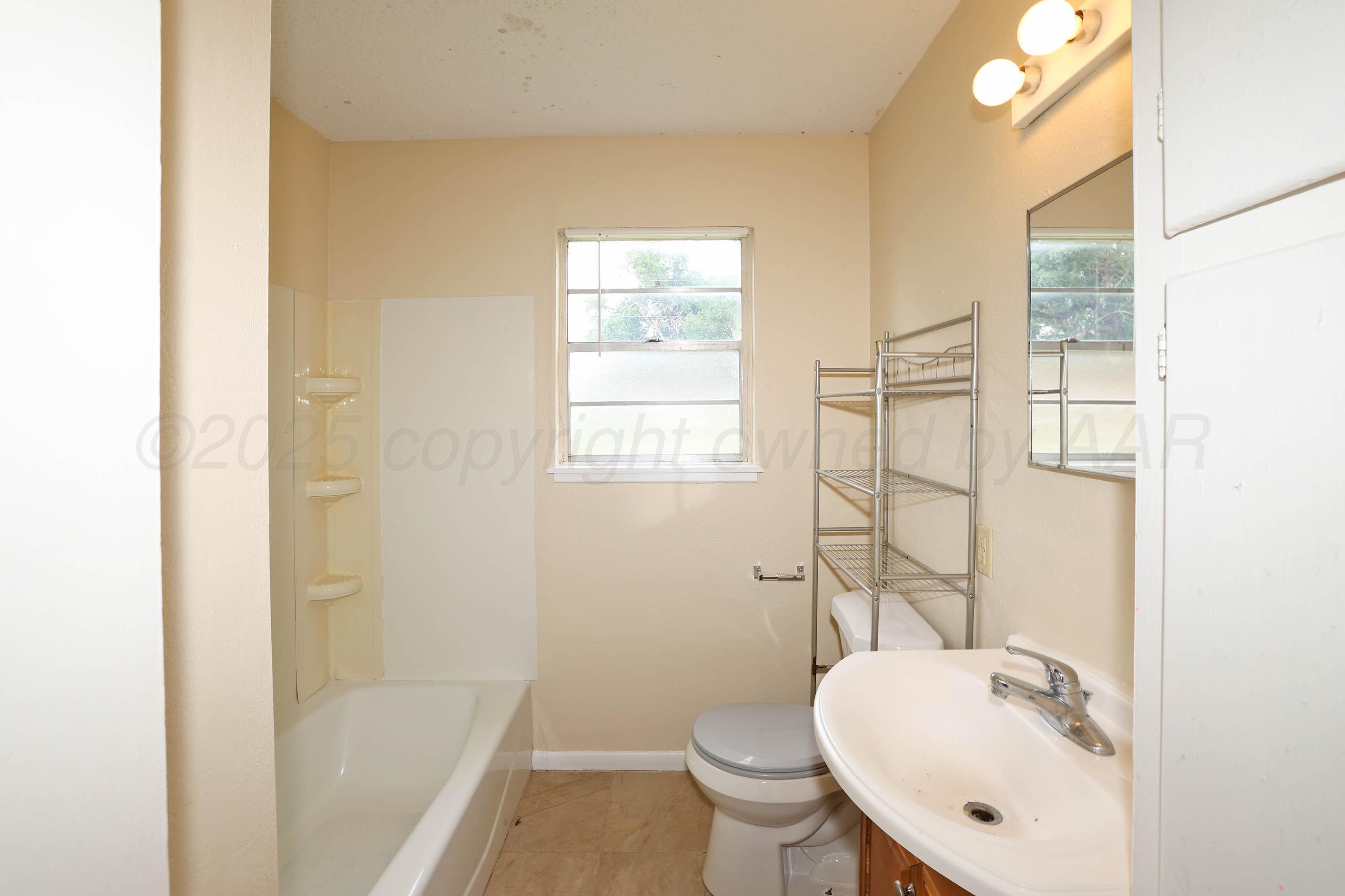 3810 Mesa Verde Drive Amarillo, TX 79107 - Photo 17 of 21 a bathroom with a sink toilet and shower