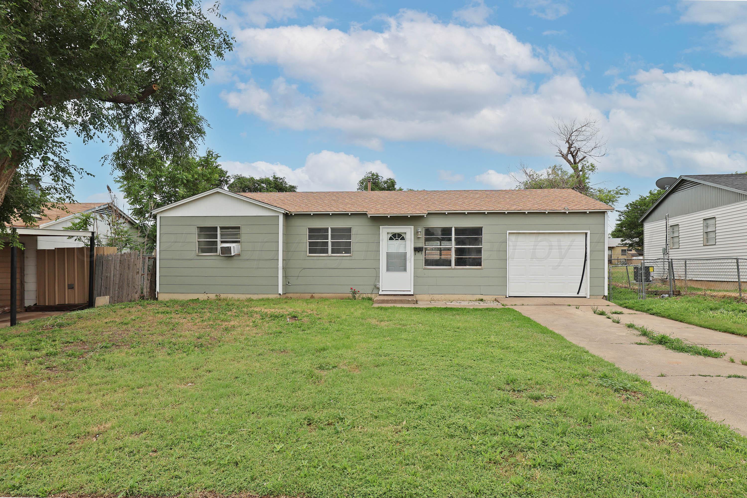 3810 Mesa Verde Drive Amarillo, TX 79107 - Photo 2 of 21 a front view of a house with a garden