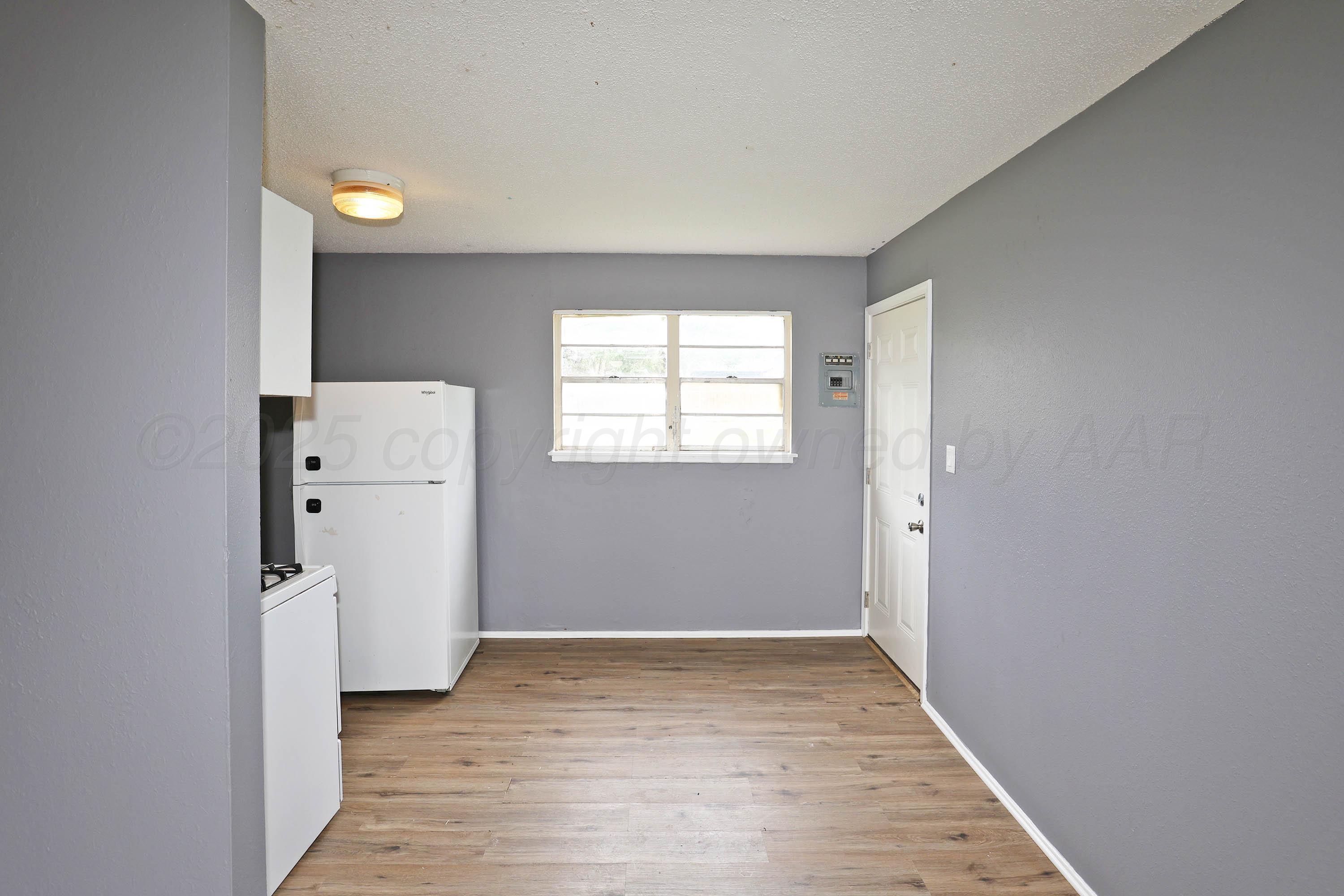 3810 Mesa Verde Drive Amarillo, TX 79107 - Photo 6 of 21 wooden floor in an empty room with a window