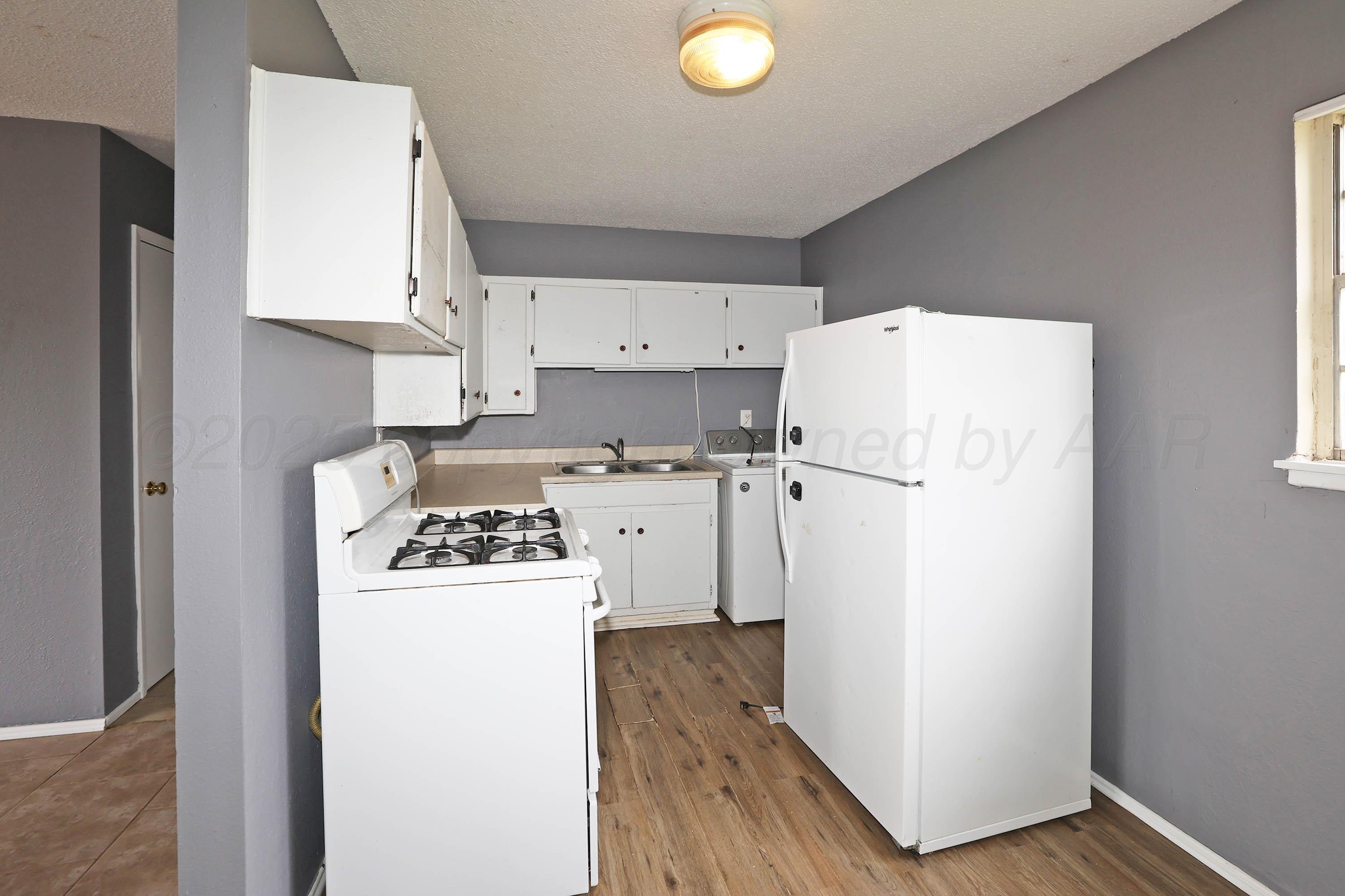 3810 Mesa Verde Drive Amarillo, TX 79107 - Photo 8 of 21 a white refrigerator freezer sitting inside of a kitchen