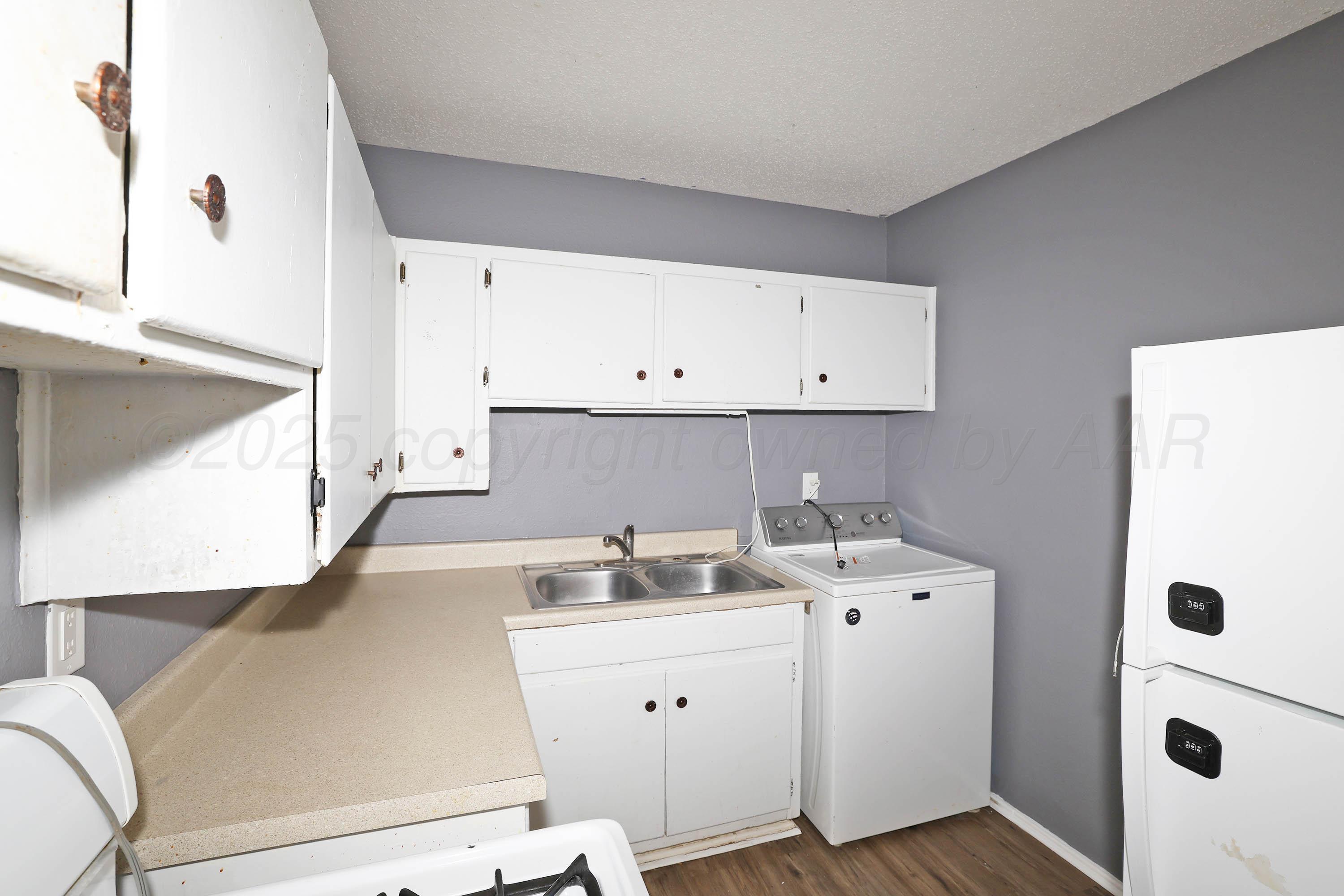 3810 Mesa Verde Drive Amarillo, TX 79107 - Photo 9 of 21 a kitchen with a sink a stove and cabinets