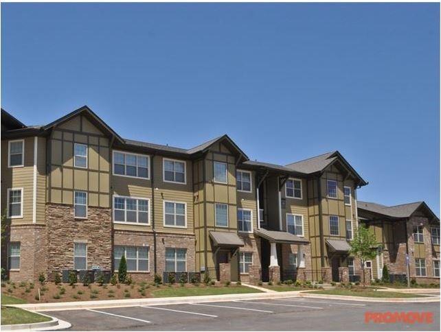 1836 Roswell Street, Unit 6304 Smyrna, GA 30080 - Photo 1 of 9 a front view of a residential apartment building with a yard