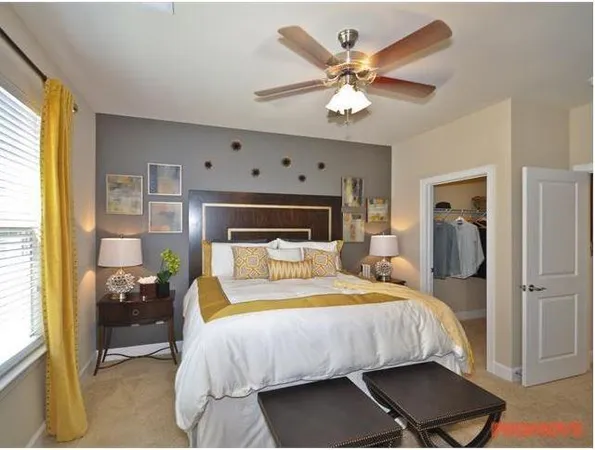 a bedroom with a bed and a chandelier
