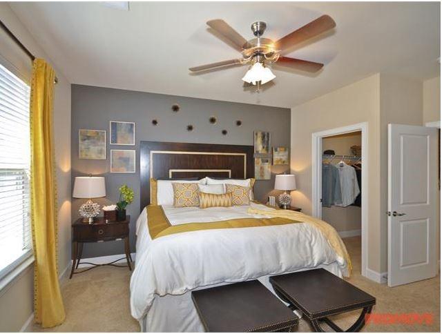 1836 Roswell Street, Unit 6304 Smyrna, GA 30080 - Photo 5 of 9 a bedroom with a bed and a chandelier