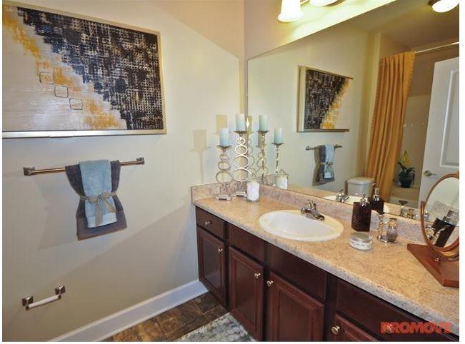 1836 Roswell Street, Unit 6304 Smyrna, GA 30080 - Photo 6 of 9 a bathroom with a granite countertop sink and a mirror